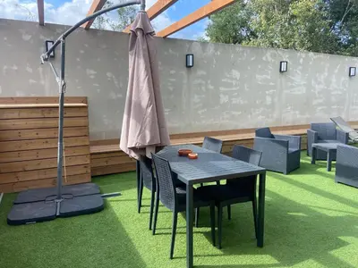 a patio with a table and chairs and an umbrella at Casa Chiaverini in Lecci