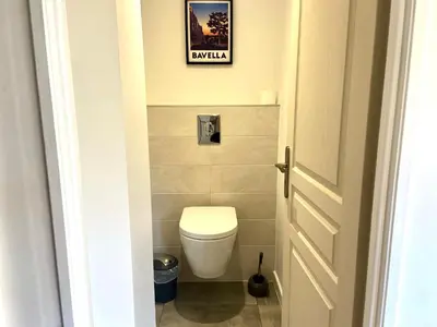 a bathroom with a toilet and a picture on the wall at Casa Chiaverini in Lecci