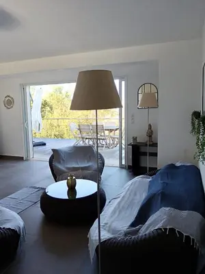 a living room with a couch and a table at Villa en Corse du Sud - Golf d'Ajaccio in Coti-Chiavari