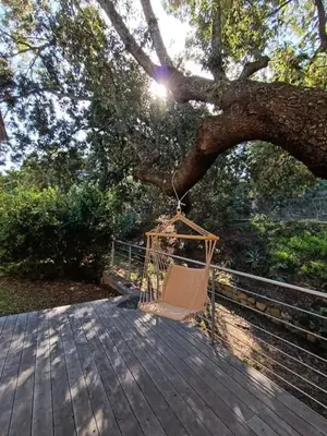 a hammock hanging from a tree on a wooden deck at Villa en Corse du Sud - Golf d'Ajaccio in Coti-Chiavari