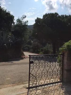 a metal gate in front of a road at Villa en Corse du Sud - Golf d'Ajaccio in Coti-Chiavari
