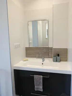 a bathroom with a sink and a mirror at Villa en Corse du Sud - Golf d'Ajaccio in Coti-Chiavari