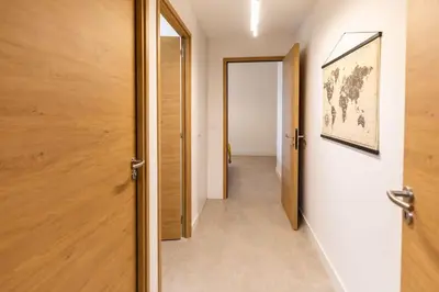 a hallway with a door leading to a room with a hallway at Appartement T3 Porto Vecchio in Porto-Vecchio