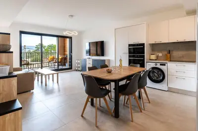 a kitchen and dining room with a table and chairs at Appartement T3 Porto Vecchio in Porto-Vecchio