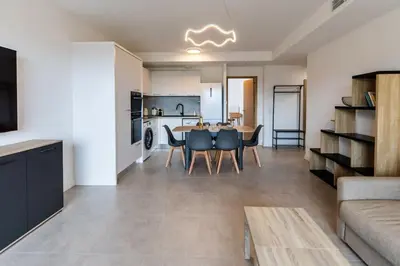a kitchen and dining room with a table and chairs at Appartement T3 Porto Vecchio in Porto-Vecchio