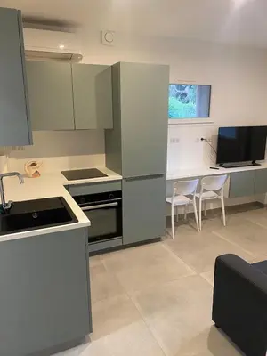 a kitchen with stainless steel appliances and a table at Charmant appartement hyper centre in Ajaccio