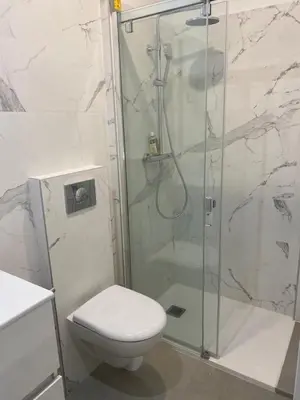 a bathroom with a shower with a toilet and a sink at Charmant appartement hyper centre in Ajaccio