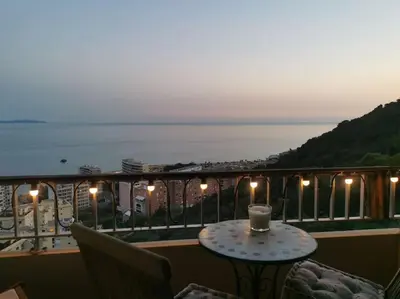 a candle sitting on a table on a balcony at Bel appartement cozy avec magnifique vue mer in Ajaccio