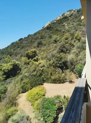 a view of a mountain from a balcony of a house at Bel appartement cozy avec magnifique vue mer in Ajaccio