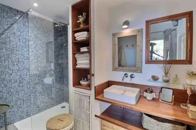 a bathroom with a sink and a shower at Bel appartement cozy avec magnifique vue mer in Ajaccio