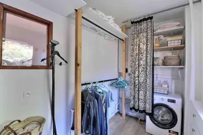 a laundry room with a washing machine and a window at Bel appartement cozy avec magnifique vue mer in Ajaccio