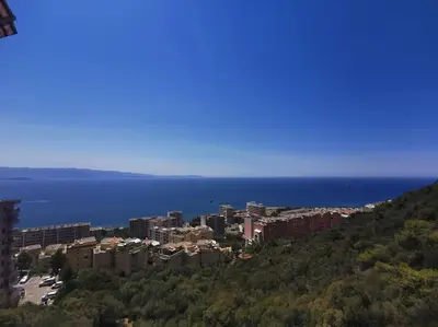 a city on a hill next to the water at Bel appartement cozy avec magnifique vue mer in Ajaccio