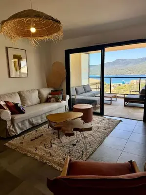 a living room with a couch and a table at Magnifique appart T3 vue mer in Propriano