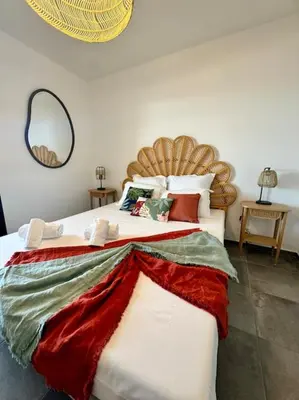 a bedroom with a large bed with red and white pillows at Magnifique appart T3 vue mer in Propriano