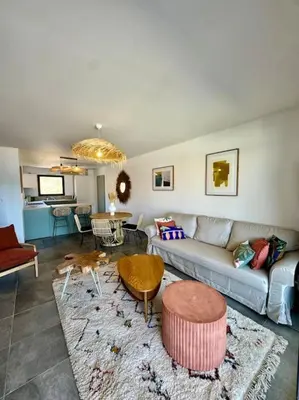 a living room with a couch and a table at Magnifique appart T3 vue mer in Propriano