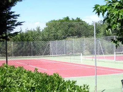 a tennis court with two tennis courts at Studio les pieds dans l'eau in San-Nicolao