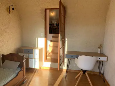 a room with a bed and a desk and a mirror at Maison indépendante Haute-Corse mer et montagne in Santo-Pietro-di-Tenda