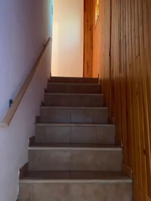 a set of stairs in a house with a door at Maison indépendante Haute-Corse mer et montagne in Santo-Pietro-di-Tenda