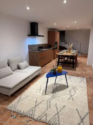a living room with a white couch and a table at Spacieux 3 chambres Centre-ville de Porto-Vecchio in Porto-Vecchio