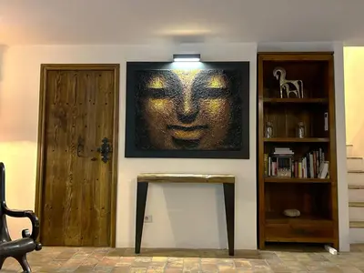 a room with a picture of a face on the wall at Villa de type bergerie 3 chambres avec piscine in Sotta