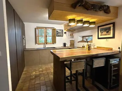 a kitchen with a large wooden island in the middle at Villa de type bergerie 3 chambres avec piscine in Sotta