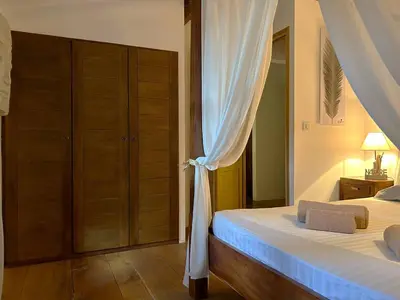 a bedroom with a bed with a white curtain at Villa de type bergerie 3 chambres avec piscine in Sotta