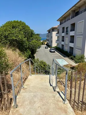 a stairway leading up to a building with a building at Appart tout équipé et vue sur la mer in Propriano