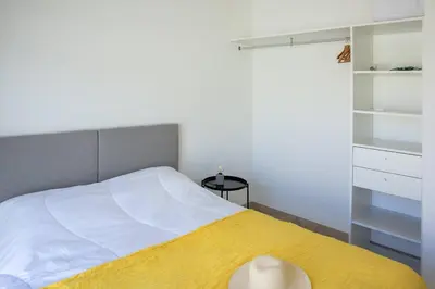 a bedroom with a bed with a yellow blanket at Villa 3 chambres avec piscine privative in Porto-Vecchio