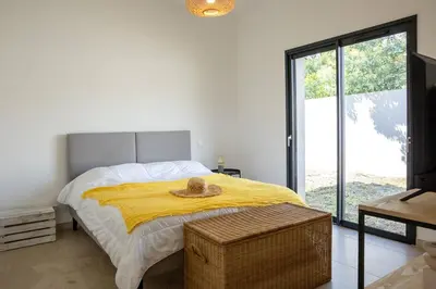 a bedroom with a bed with a hat on it at Villa 3 chambres avec piscine privative in Porto-Vecchio