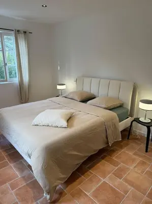 a bedroom with a large bed with two pillows at Spacieux et lumineux 2 chambres vue mer Centre-ville de Porto-Vecchio in Porto-Vecchio