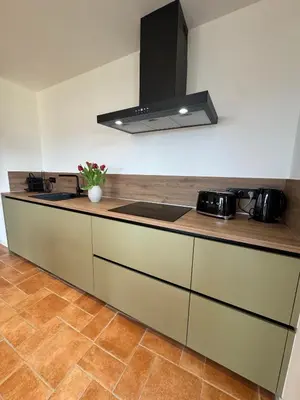 a kitchen with a sink and a stove top oven at Spacieux et lumineux 2 chambres vue mer Centre-ville de Porto-Vecchio in Porto-Vecchio
