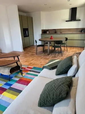 a living room with a couch and a table at Spacieux et lumineux 2 chambres vue mer Centre-ville de Porto-Vecchio in Porto-Vecchio