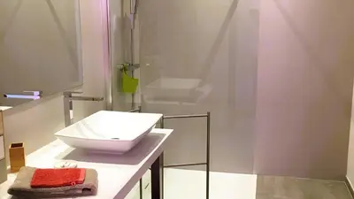 a bathroom with a white sink and a shower at Villa Suarticcia, 6 pers, piscine chauffée, 3 min plage en voiture in Sainte-Lucie de Porto-Vecchio