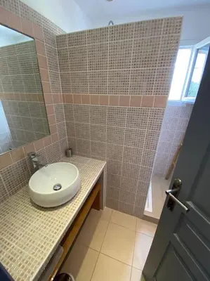 a bathroom with a sink and a mirror at Maison jasmin Porto Vecchio in Porto-Vecchio
