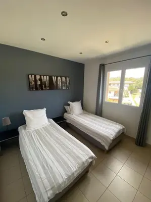 two beds sitting next to each other in a room at Maison jasmin Porto Vecchio in Porto-Vecchio