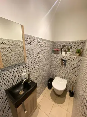 a bathroom with a black sink and a toilet at Maison jasmin Porto Vecchio in Porto-Vecchio