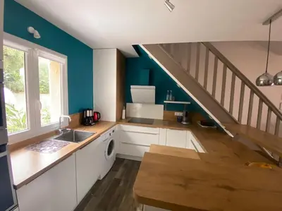 a kitchen with a sink and a staircase at Maison mer piscine Cargese à 1 heure d'Ajaccio in Cargèse