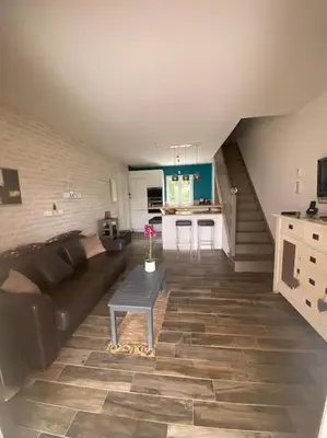 a living room with a couch and a table at Maison mer piscine Cargese à 1 heure d'Ajaccio in Cargèse