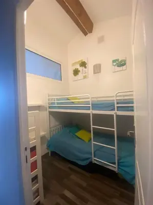 a bedroom with two bunk beds in a room at Maison mer piscine Cargese à 1 heure d'Ajaccio in Cargèse