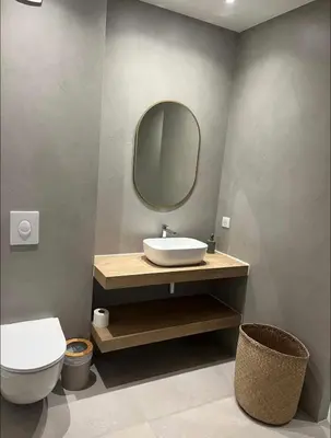 a bathroom with a sink and a toilet and a mirror at Villa vue sur le Golf 1 in Olmeto