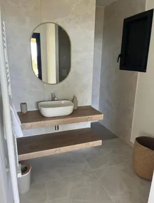 a bathroom with a sink and a mirror at Villa vue sur le Golf 1 in Olmeto