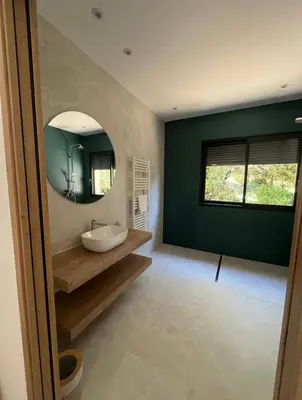 a bathroom with a sink and a mirror at Villa vue sur le Golf 1 in Olmeto