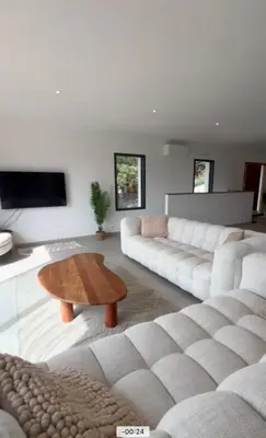 a living room with a white couch and a coffee table at Villa vue sur le Golf 1 in Olmeto