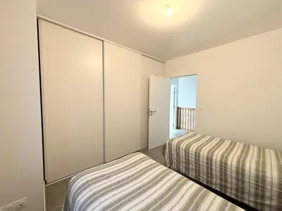 a bedroom with two beds and a large closet at Duplex Tour d'Omigna Cargèse in Cargèse