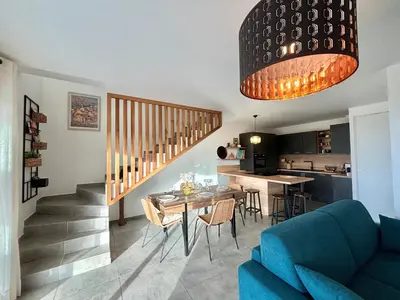 a living room with a blue couch and a table at Duplex Tour d'Omigna Cargèse in Cargèse