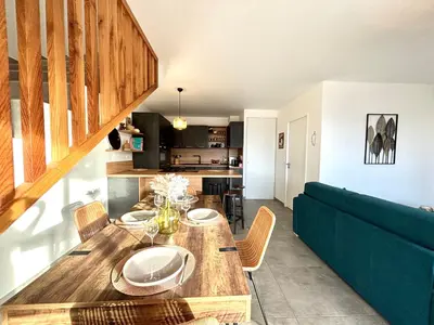a living room with a table and a couch at Duplex Tour d'Omigna Cargèse in Cargèse