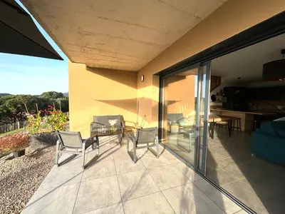 a patio with chairs and a table on a house at Duplex Tour d'Omigna Cargèse in Cargèse