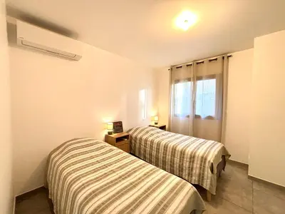 a room with two beds and a window at Duplex Tour d'Omigna Cargèse in Cargèse