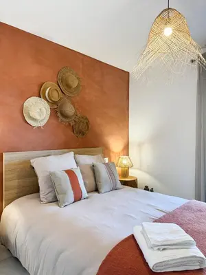a bedroom with a large white bed with a wooden headboard at Nouveauté ! Bel'Orizonte T - Deux Chambres proche mer in Propriano