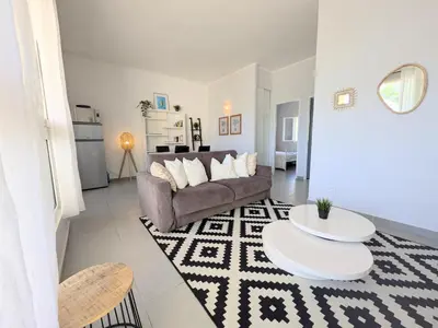 a living room with a couch and a table at La Perla di Santa Maria - Vue mer, plage à 100 m in Santa-Maria-Poggio